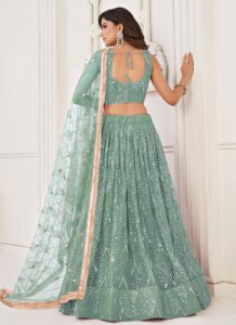Turquoise net umbrella lehenga choli with heavy hand embroidery back view